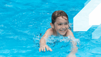 Young male swimming in the pool.